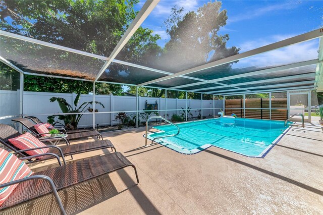 5948 Mirror Lake Rd, Sarasota, FL 34238 - view of swimming pool featuring a fenced backyard, a patio, and glass enclosure
