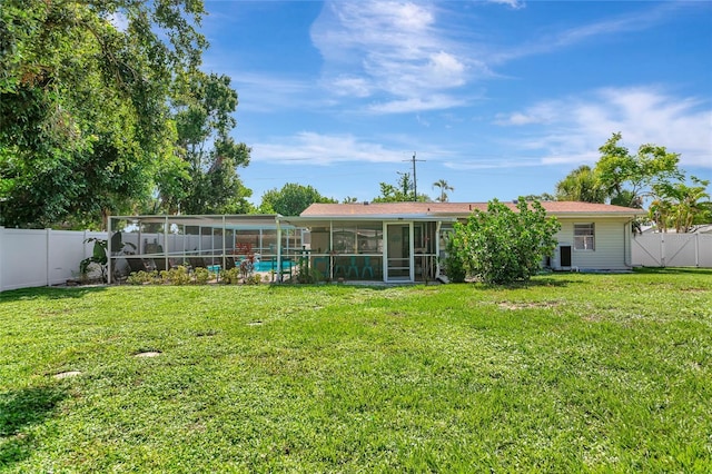 5948 Mirror Lake Rd, Sarasota, FL 34238 - rear view of house featuring a sunroom and a fenced backyard