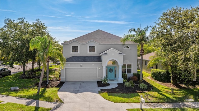 8804 Founders Cir, Palmetto, FL 34221 - view of front of home with a garage, stucco siding, concrete driveway, and a front lawn