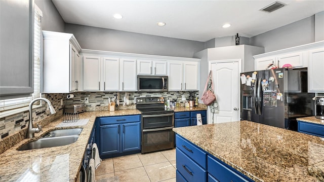 8804 Founders Cir, Palmetto, FL 34221 - kitchen featuring appliances with stainless steel finishes, blue cabinets, tasteful backsplash, and recessed lighting
