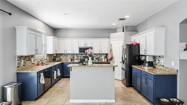 8804 Founders Cir, Palmetto, FL 34221 - kitchen featuring blue cabinets, appliances with stainless steel finishes, a kitchen island, white cabinetry, and recessed lighting