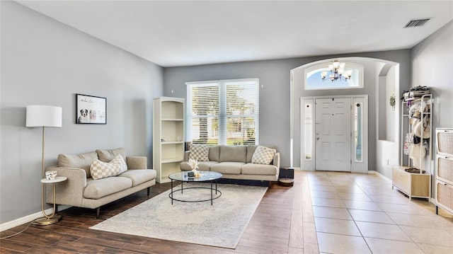 8804 Founders Cir, Palmetto, FL 34221 - living room featuring wood finished floors, a chandelier, and arched walkways