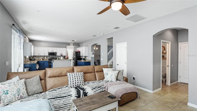 8804 Founders Cir, Palmetto, FL 34221 - living room featuring light tile patterned floors, ceiling fan, stairs, arched walkways, and recessed lighting