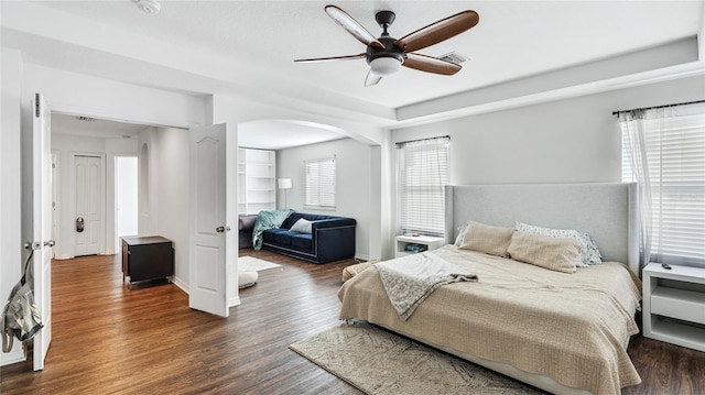 8804 Founders Cir, Palmetto, FL 34221 - bedroom featuring wood finished floors, arched walkways, and ceiling fan
