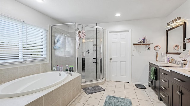 8804 Founders Cir, Palmetto, FL 34221 - full bathroom with vanity, a garden tub, a stall shower, tile patterned flooring, and recessed lighting