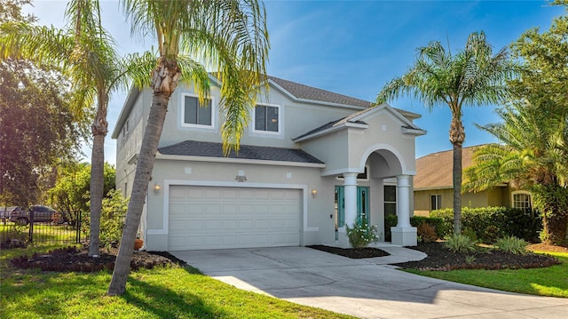 8804 Founders Cir, Palmetto, FL 34221 - view of front of house featuring stucco siding, driveway, a garage, and roof with shingles