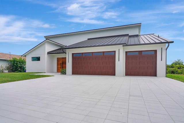 289 Long Meadow Ln, Rotonda West, FL 33947 - modern home featuring a standing seam roof, stucco siding, and a garage