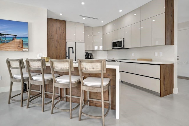 289 Long Meadow Ln, Rotonda West, FL 33947 - kitchen featuring built in fridge, modern cabinets, finished concrete floors, and recessed lighting
