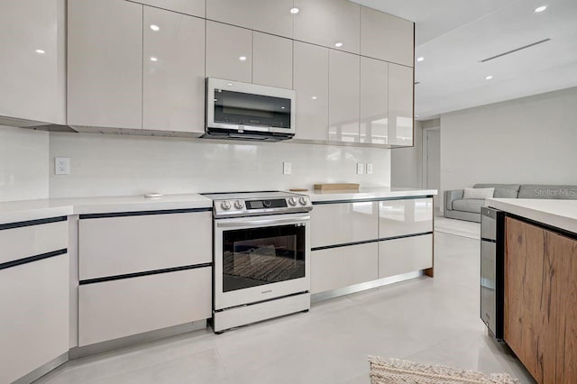 289 Long Meadow Ln, Rotonda West, FL 33947 - kitchen with appliances with stainless steel finishes, modern cabinets, light countertops, open floor plan, and recessed lighting