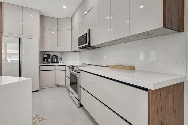289 Long Meadow Ln, Rotonda West, FL 33947 - kitchen with electric range, modern cabinets, white cabinetry, light countertops, and refrigerator