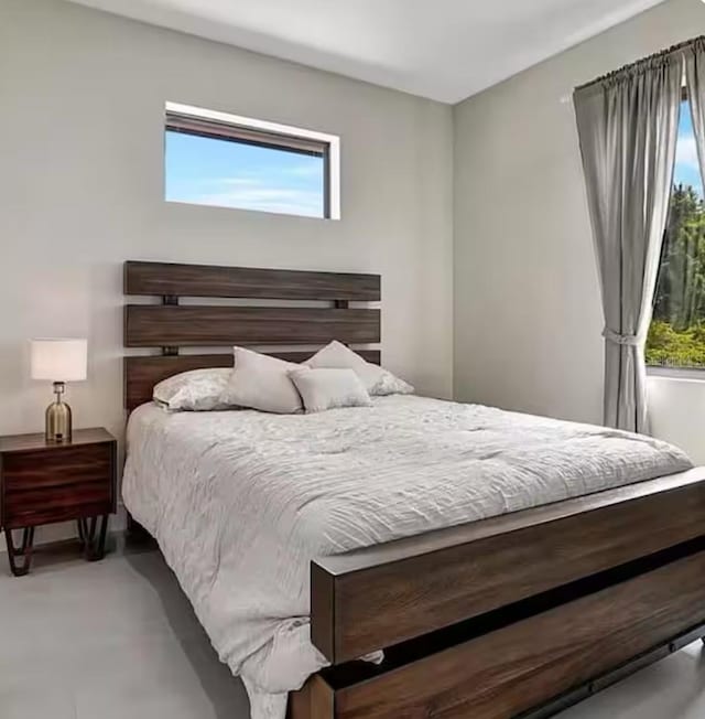 289 Long Meadow Ln, Rotonda West, FL 33947 - bedroom with multiple windows and concrete floors