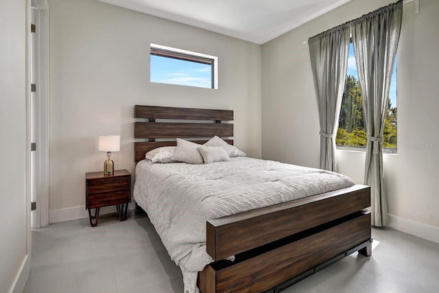 289 Long Meadow Ln, Rotonda West, FL 33947 - bedroom featuring baseboards and finished concrete flooring