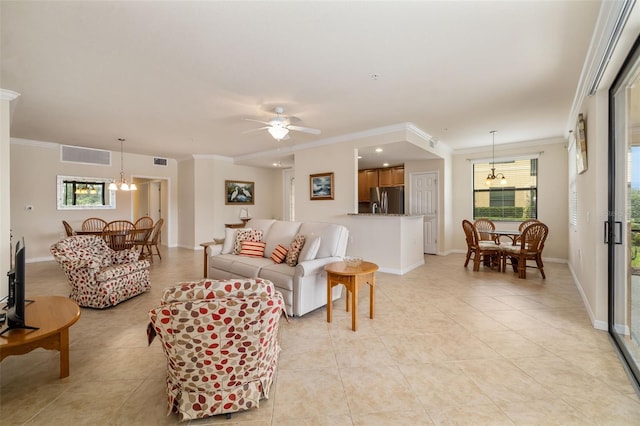 6923 Grand Estuary Trl Unit 101, Bradenton, FL 34212 - living room featuring crown molding, light tile patterned floors, a ceiling fan, and a chandelier