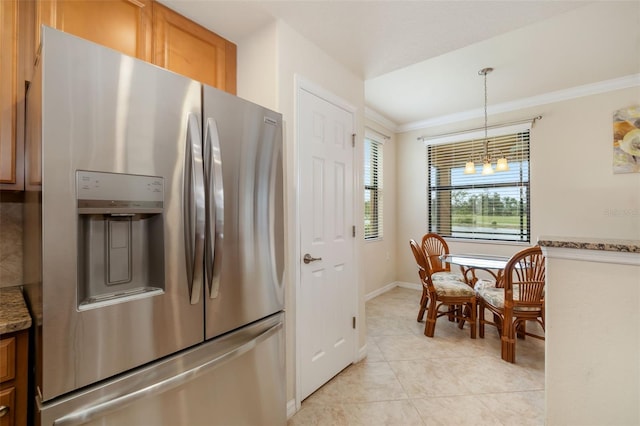 6923 Grand Estuary Trl Unit 101, Bradenton, FL 34212 - kitchen with stainless steel refrigerator with ice dispenser, a chandelier, light tile patterned floors, ornamental molding, and light stone countertops
