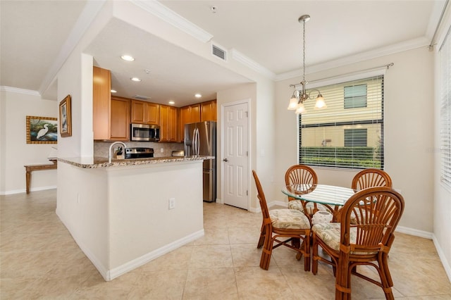 6923 Grand Estuary Trl Unit 101, Bradenton, FL 34212 - kitchen with appliances with stainless steel finishes, crown molding, light stone countertops, decorative backsplash, and light tile patterned floors