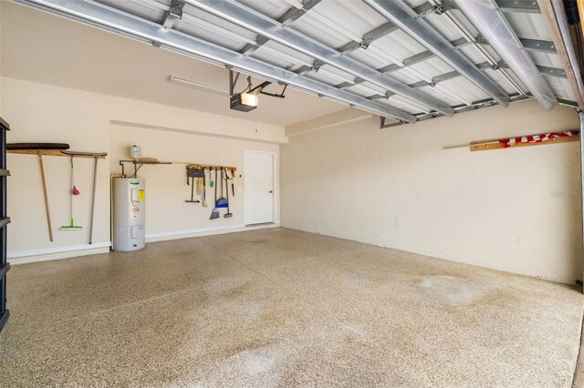 6923 Grand Estuary Trl Unit 101, Bradenton, FL 34212 - garage featuring electric water heater, a garage door opener, and concrete block wall