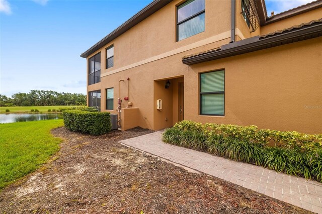 6923 Grand Estuary Trl Unit 101, Bradenton, FL 34212 - entrance to property featuring a water view, stucco siding, and a lawn