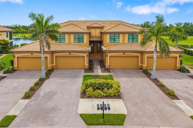 6923 Grand Estuary Trl Unit 101, Bradenton, FL 34212 - view of front of home featuring stucco siding, a tiled roof, and driveway