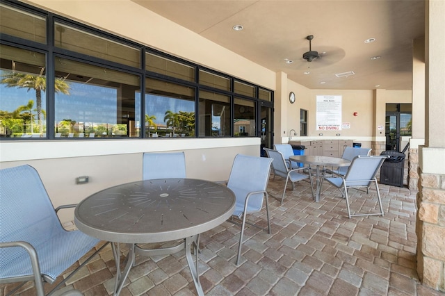 6923 Grand Estuary Trl Unit 101, Bradenton, FL 34212 - view of patio with outdoor dining space and ceiling fan