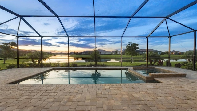 15344 Serene Shores Loop, Lakewood Ranch, FL 34211 - view of pool featuring a patio, a water view, a lanai, and a pool with connected hot tub