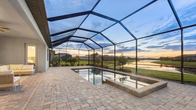 15344 Serene Shores Loop, Lakewood Ranch, FL 34211 - pool at dusk with a patio, a water view, an outdoor living space, an outdoor pool, and a lanai