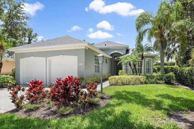 5508 Whitehead St, Bradenton, FL 34203 - view of front facade featuring stucco siding, a garage, a front yard, and roof with shingles