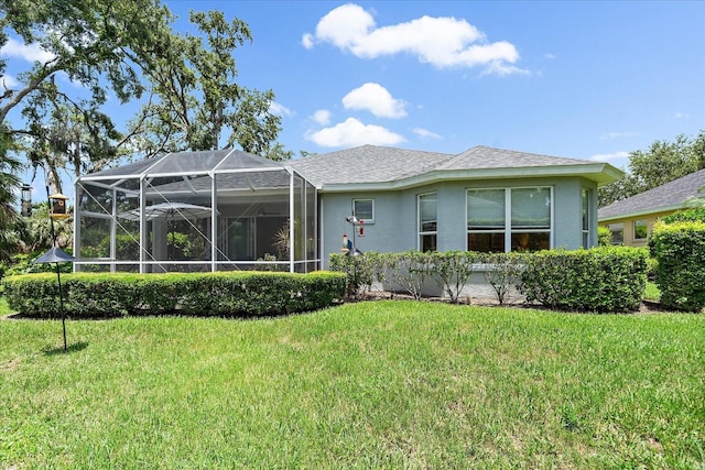 5508 Whitehead St, Bradenton, FL 34203 - rear view of property featuring a yard, stucco siding, and glass enclosure