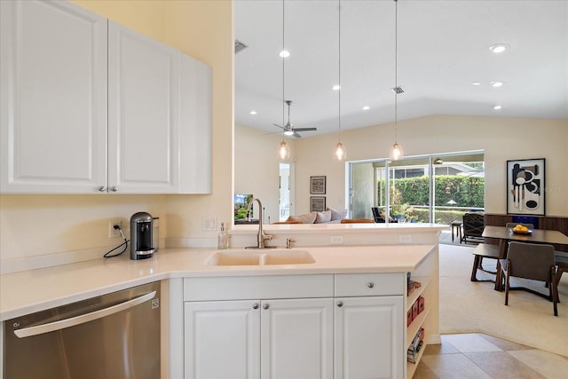 5508 Whitehead St, Bradenton, FL 34203 - kitchen with stainless steel dishwasher, open floor plan, vaulted ceiling, a peninsula, and white cabinetry