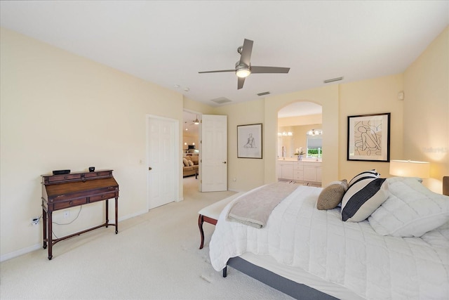 5508 Whitehead St, Bradenton, FL 34203 - bedroom featuring arched walkways, light carpet, connected bathroom, and ceiling fan