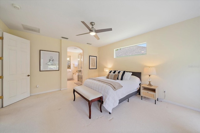 5508 Whitehead St, Bradenton, FL 34203 - bedroom with arched walkways, light colored carpet, connected bathroom, and ceiling fan