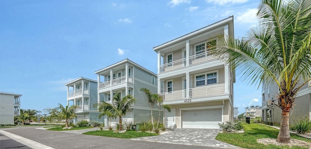 4322 Marina View Way, Cortez, FL 34215 - beach home featuring driveway, an attached garage, and a balcony