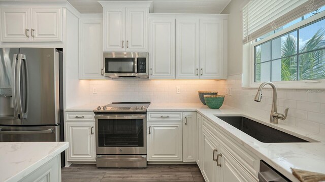 4322 Marina View Way, Cortez, FL 34215 - kitchen with appliances with stainless steel finishes, a sink, and white cabinets