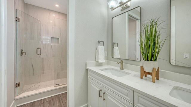 4322 Marina View Way, Cortez, FL 34215 - full bathroom featuring double vanity, a shower stall, wood finished floors, and a textured wall