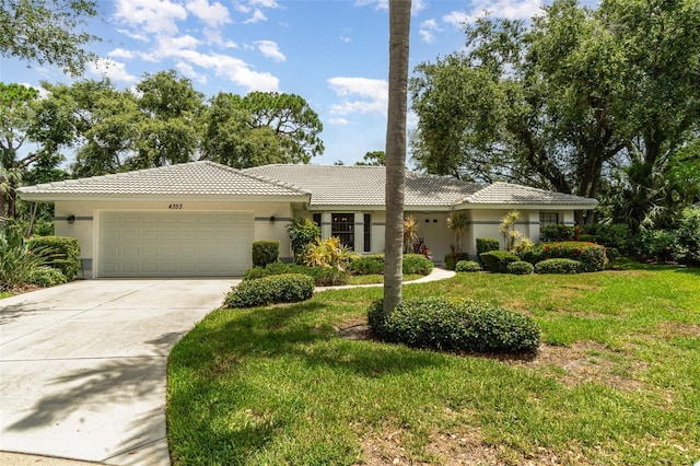 4353 Indian Point Trl, Sarasota, FL 34238 - single story home with a garage, stucco siding, a front yard, driveway, and a tiled roof