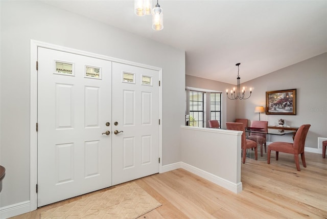4353 Indian Point Trl, Sarasota, FL 34238 - entrance foyer featuring a chandelier, light wood-type flooring, and vaulted ceiling