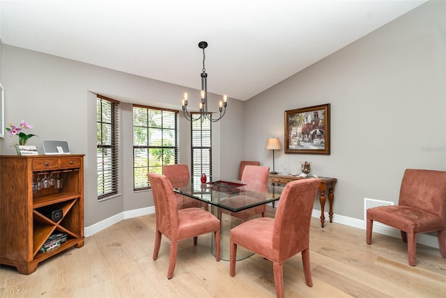 4353 Indian Point Trl, Sarasota, FL 34238 - dining room with light wood-style flooring, a chandelier, and lofted ceiling