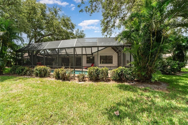 4353 Indian Point Trl, Sarasota, FL 34238 - rear view of property featuring a lawn, an outdoor pool, and a lanai
