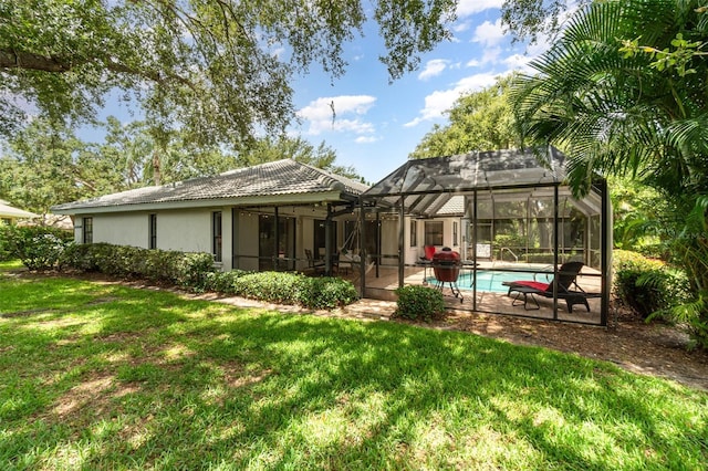 4353 Indian Point Trl, Sarasota, FL 34238 - rear view of property with a lawn, a patio area, an outdoor pool, and stucco siding