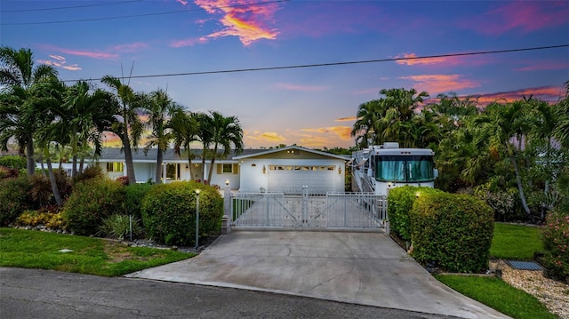 14544 Riverside Dr, Fort Myers, FL 33905 - ranch-style house featuring a garage, driveway, and a gate
