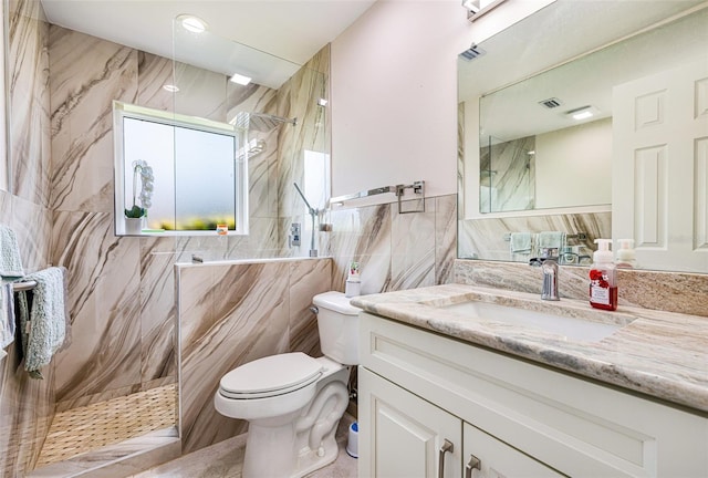 14544 Riverside Dr, Fort Myers, FL 33905 - full bathroom featuring tile walls, toilet, vanity, and a marble finish shower