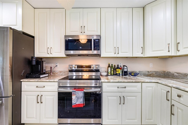 14544 Riverside Dr, Fort Myers, FL 33905 - kitchen with stainless steel appliances and white cabinetry