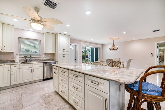 14544 Riverside Dr, Fort Myers, FL 33905 - kitchen with dishwasher, a kitchen bar, healthy amount of natural light, and recessed lighting