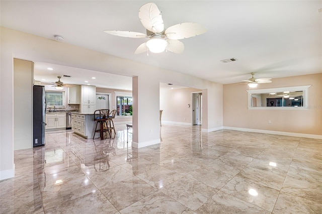 14544 Riverside Dr, Fort Myers, FL 33905 - living room with a ceiling fan, light marble finish flooring, and baseboards