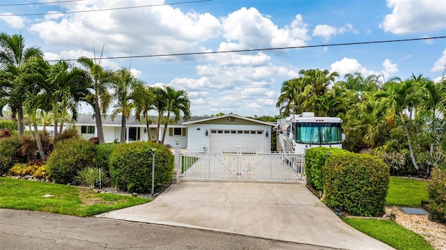 14544 Riverside Dr, Fort Myers, FL 33905 - single story home featuring a gate, concrete driveway, and an attached garage