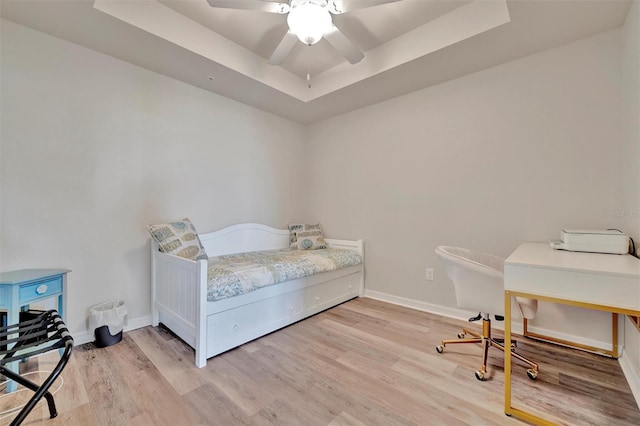 5528 Palmer Cir Unit 104, Bradenton, FL 34211 - bedroom featuring a raised ceiling, light wood-style floors, baseboards, and a desk
