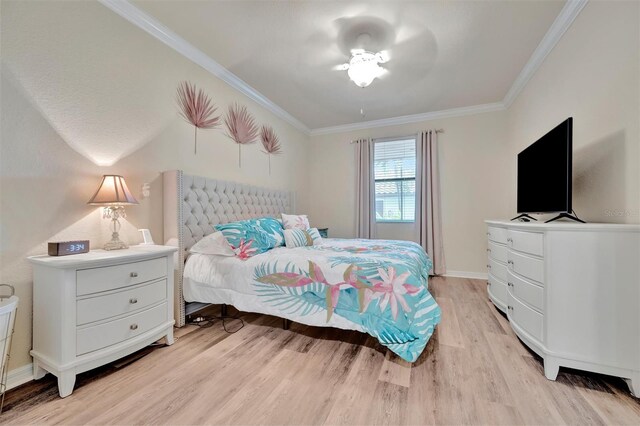 5528 Palmer Cir Unit 104, Bradenton, FL 34211 - bedroom with light wood-style floors, crown molding, and baseboards