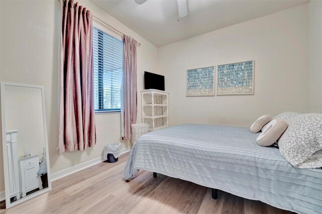 5528 Palmer Cir Unit 104, Bradenton, FL 34211 - bedroom with light wood finished floors, baseboards, and ceiling fan