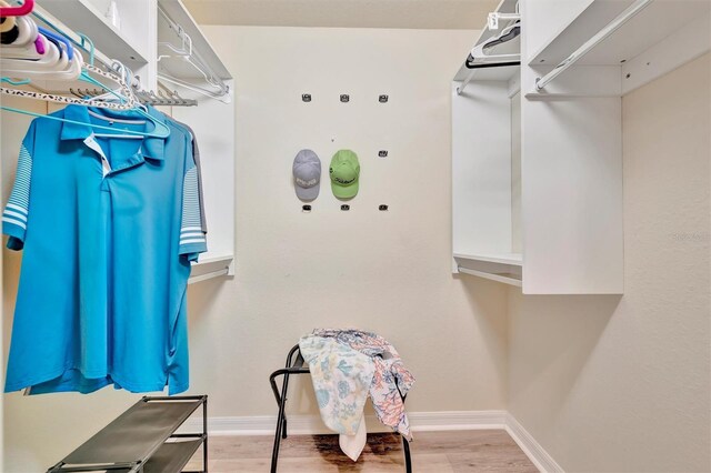 5528 Palmer Cir Unit 104, Bradenton, FL 34211 - walk in closet with wood finished floors