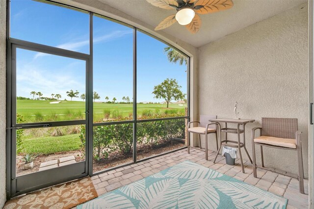 5528 Palmer Cir Unit 104, Bradenton, FL 34211 - sunroom / solarium featuring golf course view and a ceiling fan