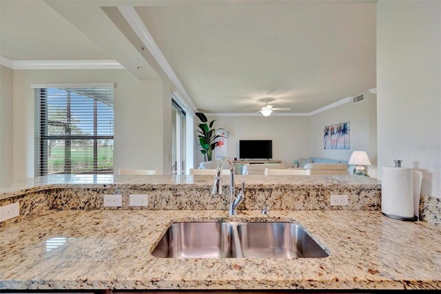 5528 Palmer Cir Unit 104, Bradenton, FL 34211 - kitchen featuring ornamental molding, a ceiling fan, open floor plan, and light stone countertops